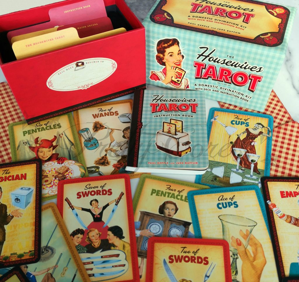 Housewives tarot box and cards showing the colour, imagery in a fun and kitch design straight from the 1950s