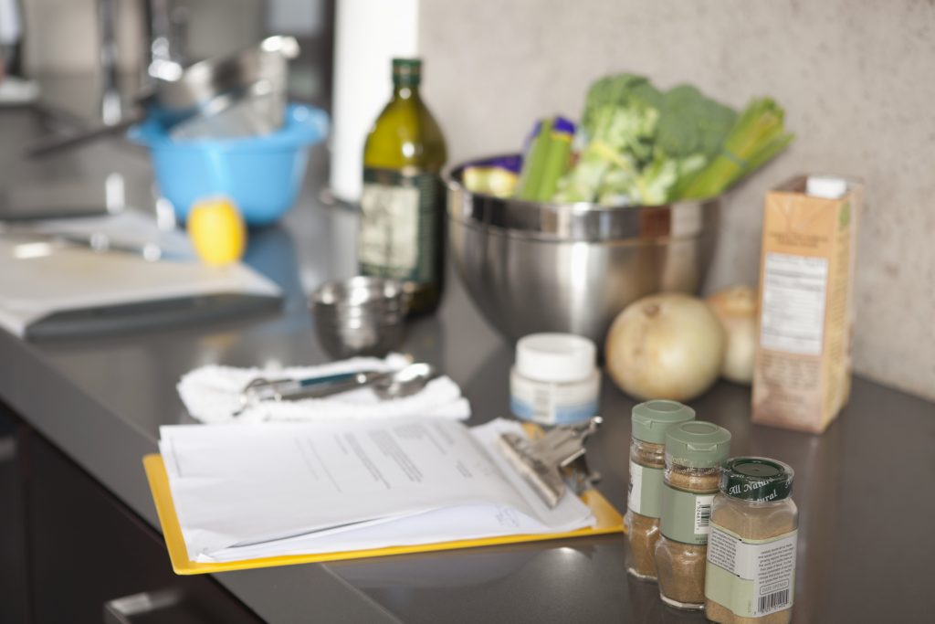 Recipe book surrounded by spices and vegetables