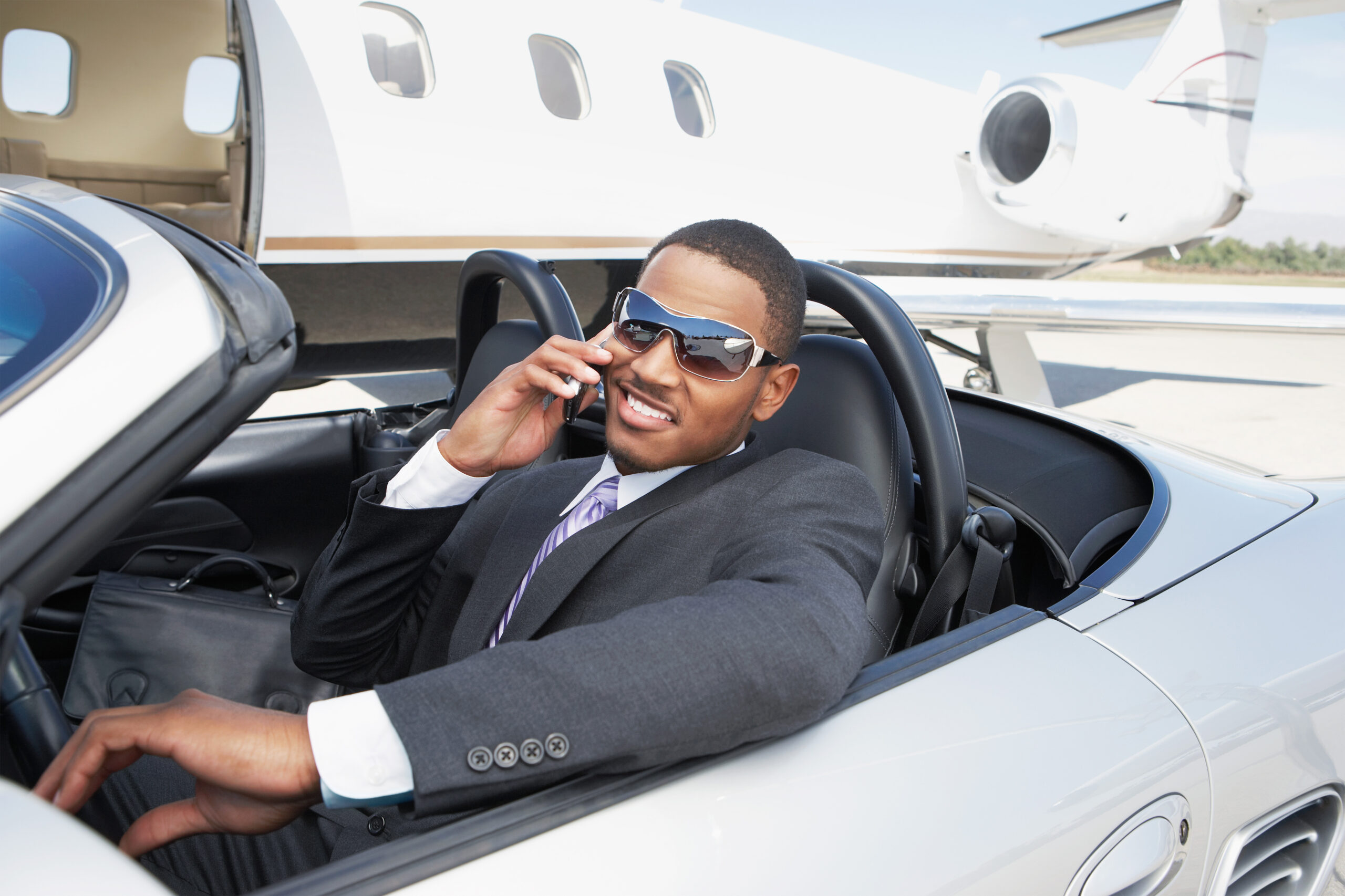 Man in a Convertible on the phone purchasing a new car
