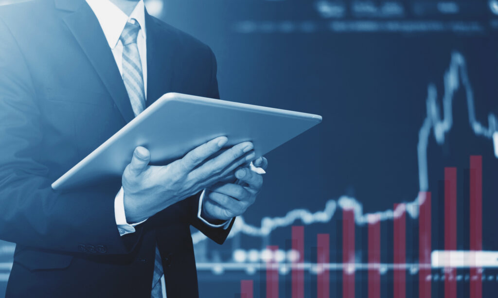 Businessman using digital tablet, raising graph background. Business growth, investment and invest in stock exchange market Top 7 Best Investment Apps in 2020