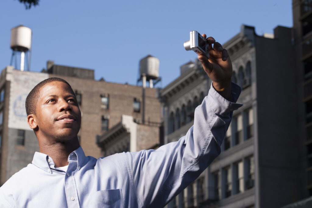 Man holding up a camera to take a selfie