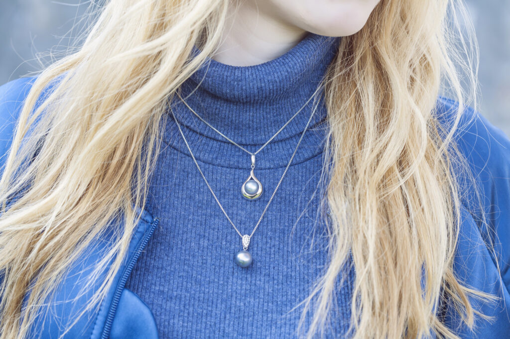 Young fashionable woman wearing luxury pendant of unique designs