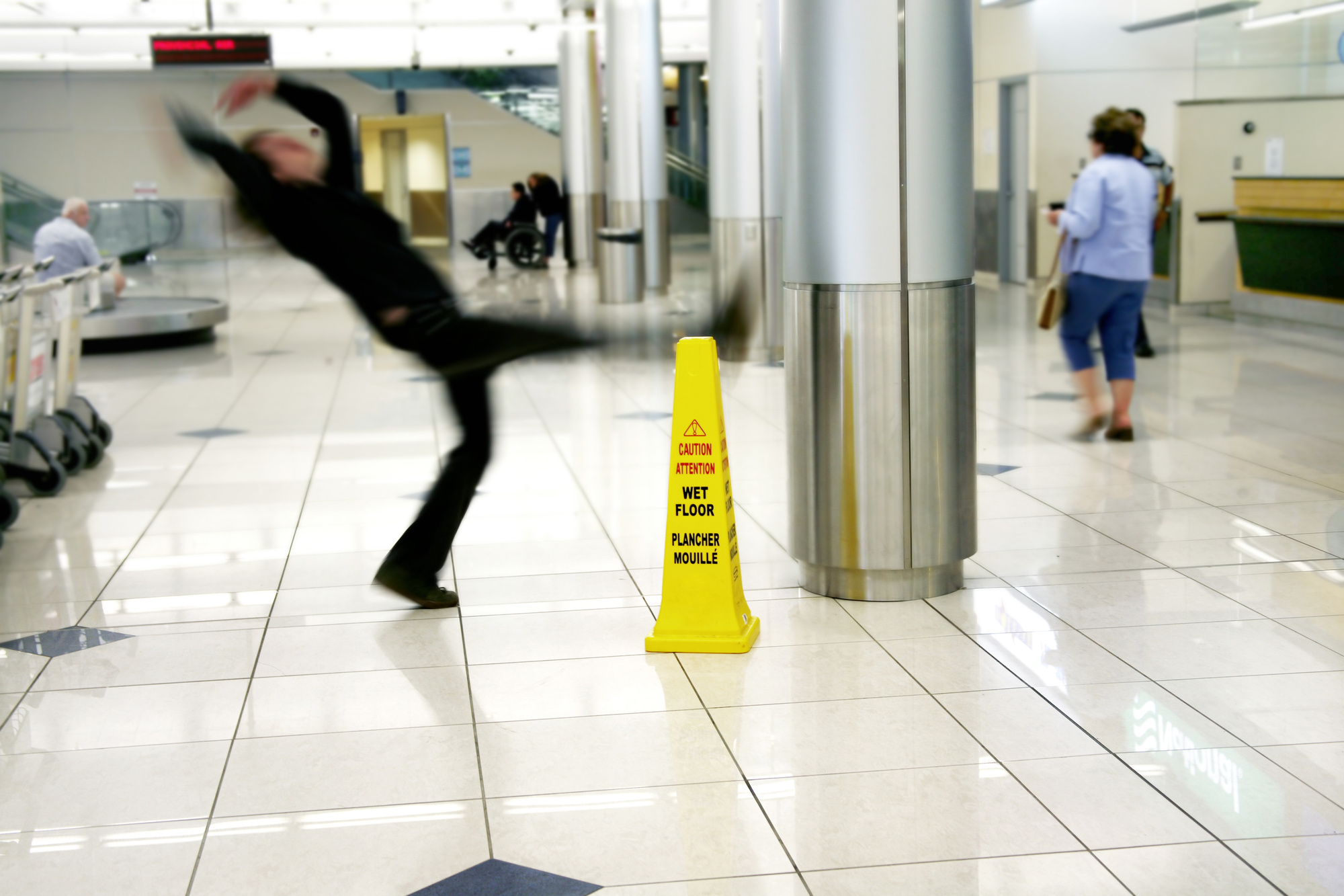 Man slips next to Wet Floor sign slip free shoes