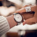 Silver watch on woman hand showing how to wear jewelry