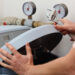 Repairing water softener, plumber with a wrench as thinking what is a water softener