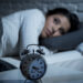 young beautiful hispanic woman at home bedroom lying in bed late at night trying to sleep suffering insomnia sleeping disorder or scared on nightmares looking sad worried and stressed