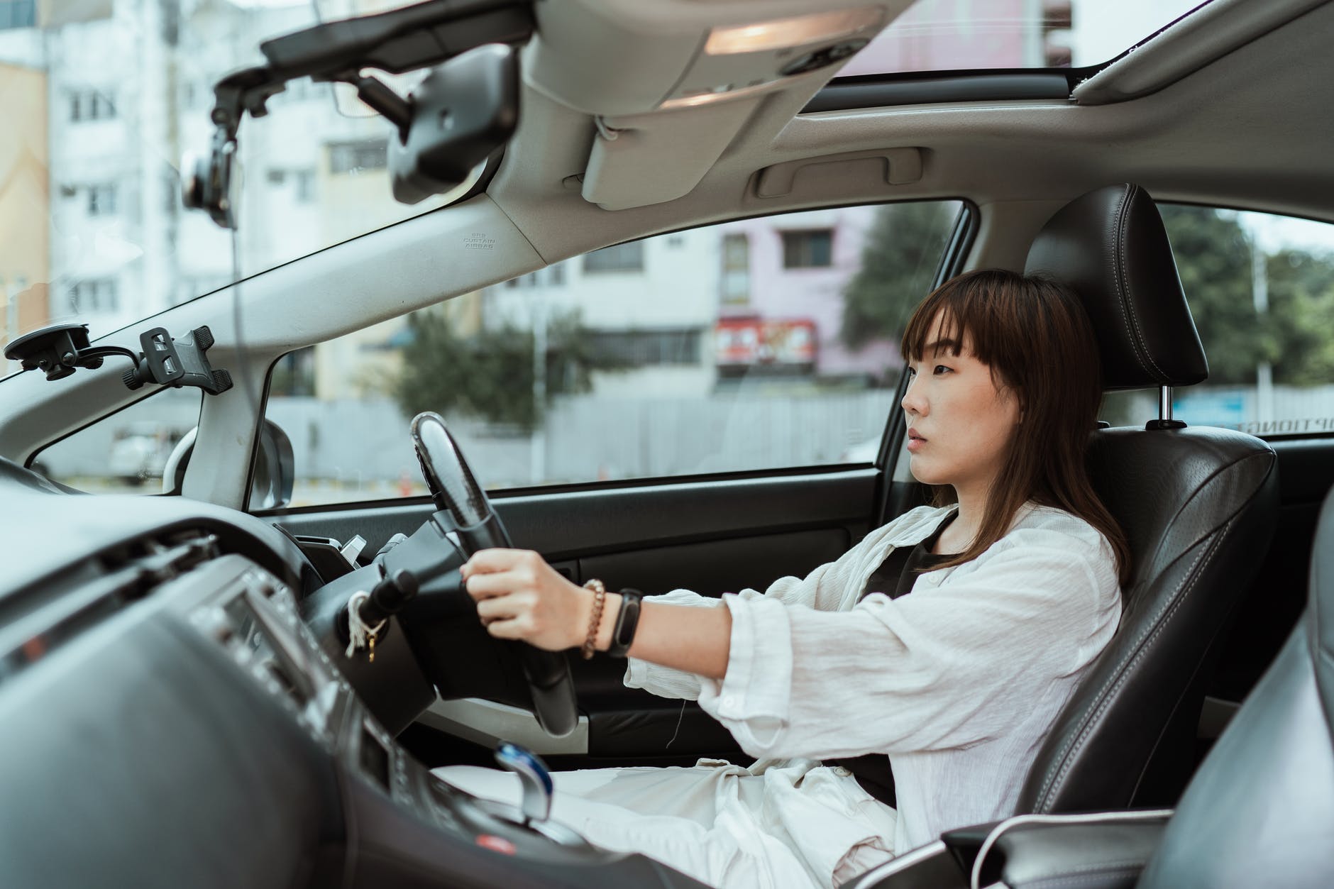 Woman sat in a new car as How To Fund The Purchase Of A New Car