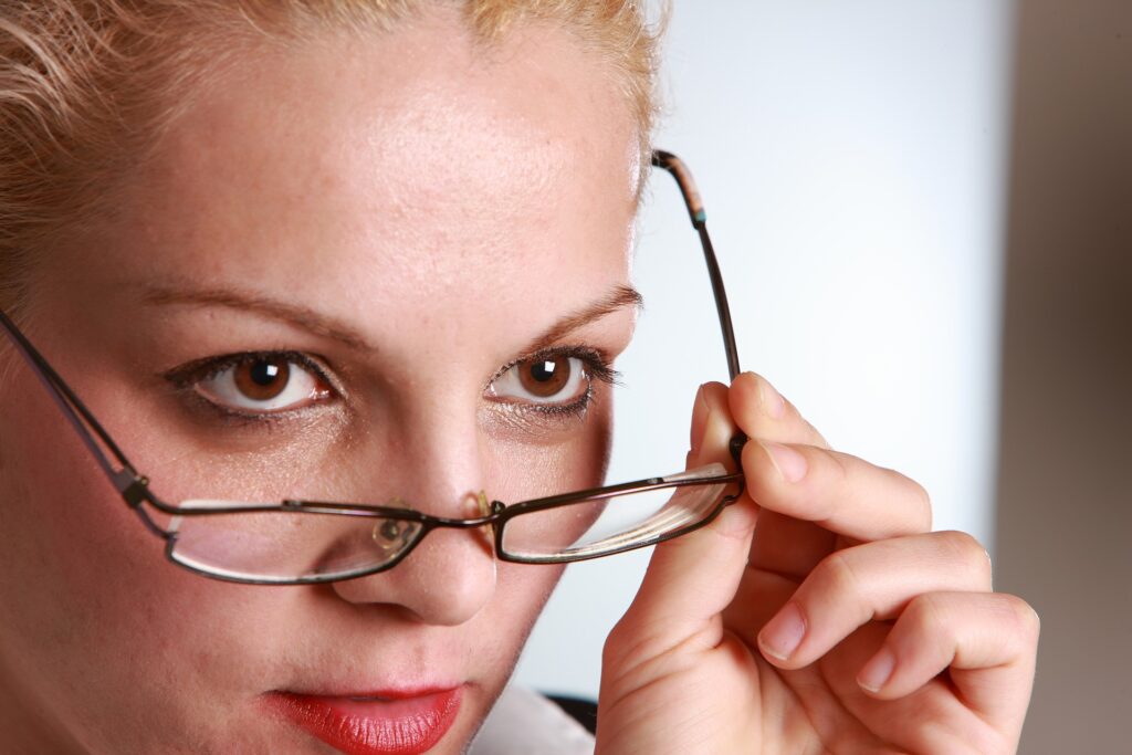 Woman taking her glasses off