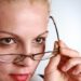 Woman taking her glasses off