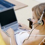 Woman on her laptop with a headset on whilst having Virtual Dates and thinking about Ideas For Gamer Dating