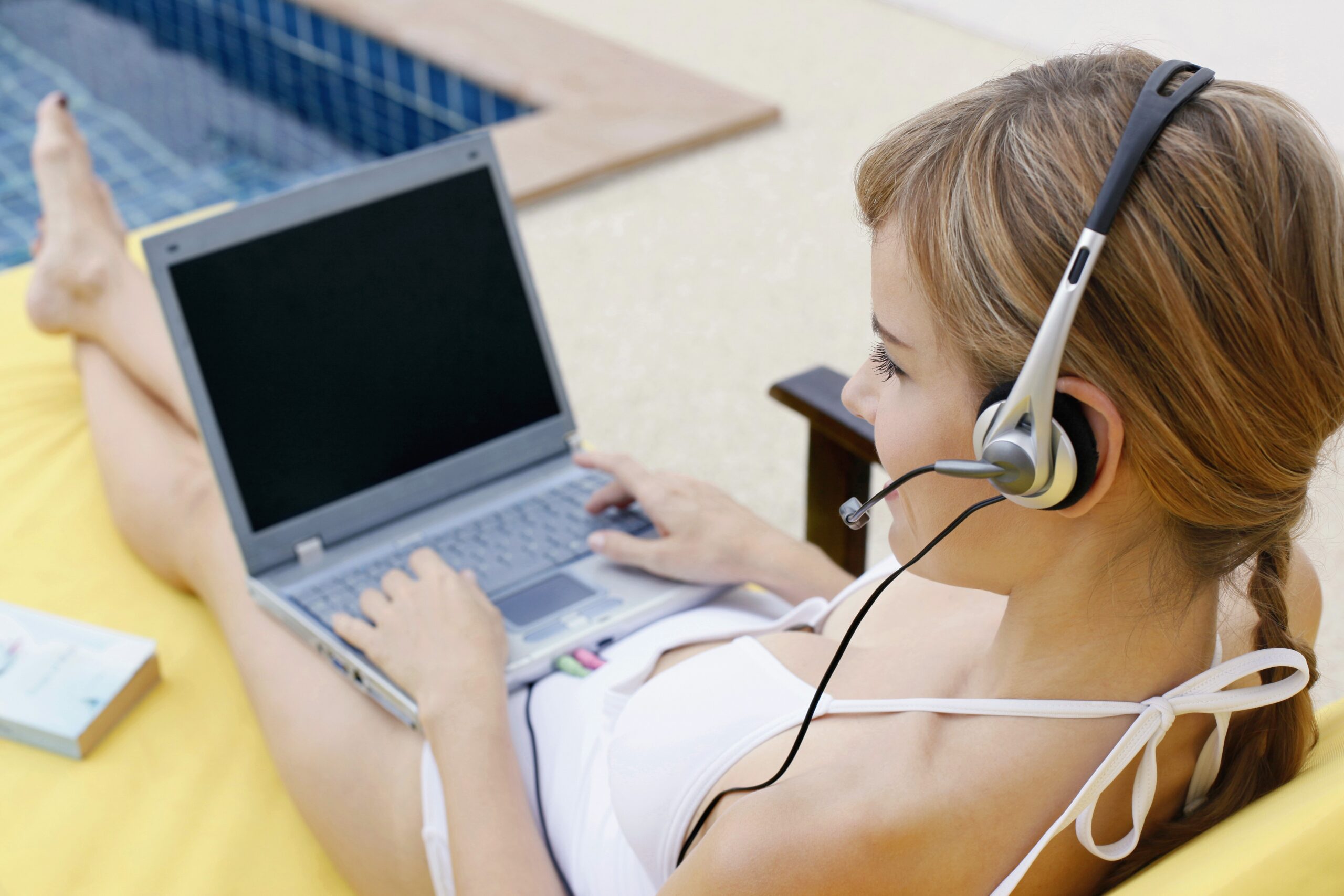 Woman on her laptop with a headset on whilst having Virtual Dates and thinking about Ideas For Gamer Dating