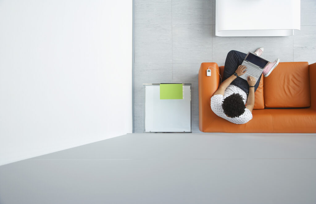 Man with a laptop sat on an orange couch 4 Ways To Have Fantastic Online Dates - Top Online Dating Ideas