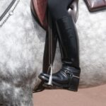 Person n a horse showing their horse riding boots