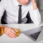 Man drinking at the office Alcoholism and Genetics: The Sobering Truth