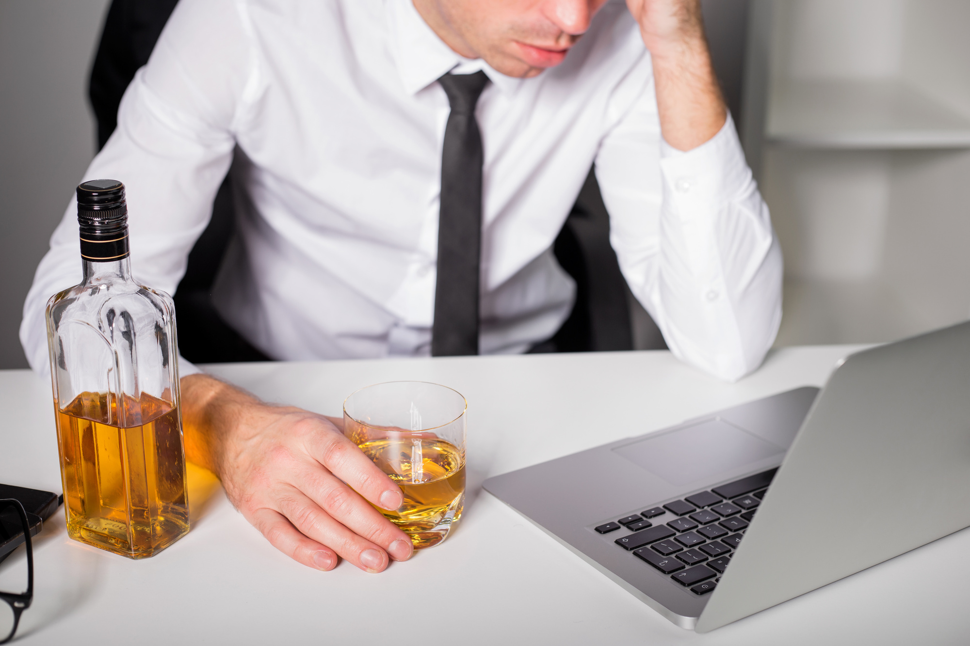 Man drinking at the office Alcoholism and Genetics: The Sobering Truth