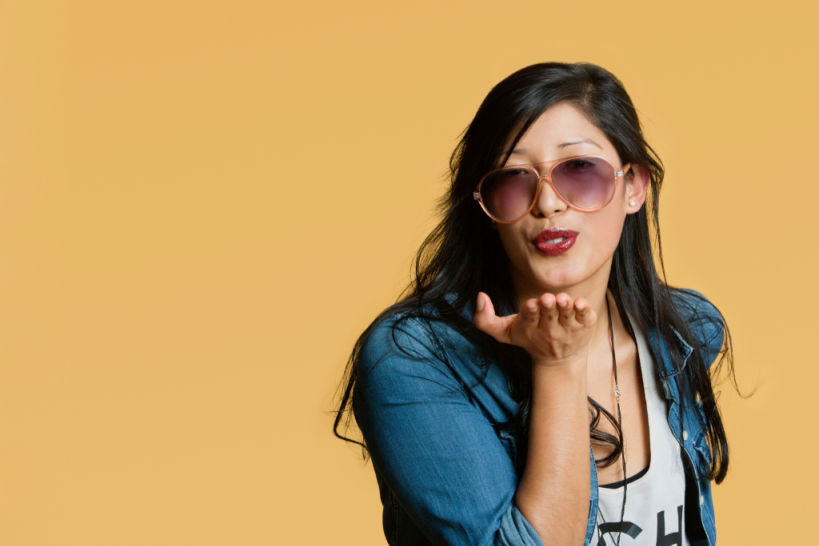How to Make Better Decisions for Yourself Young woman blowing kisses over colored background